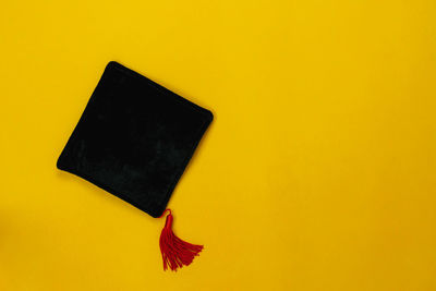 Close-up of yellow umbrella against orange background