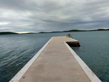 Pier over sea against sky