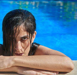 Portrait of shirtless man swimming in pool