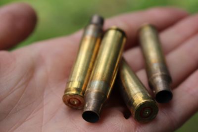 Cropped image of hand holding bullets