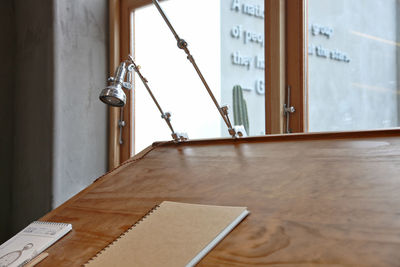 Close-up of open book on table against building