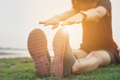 Low section of woman lying on field