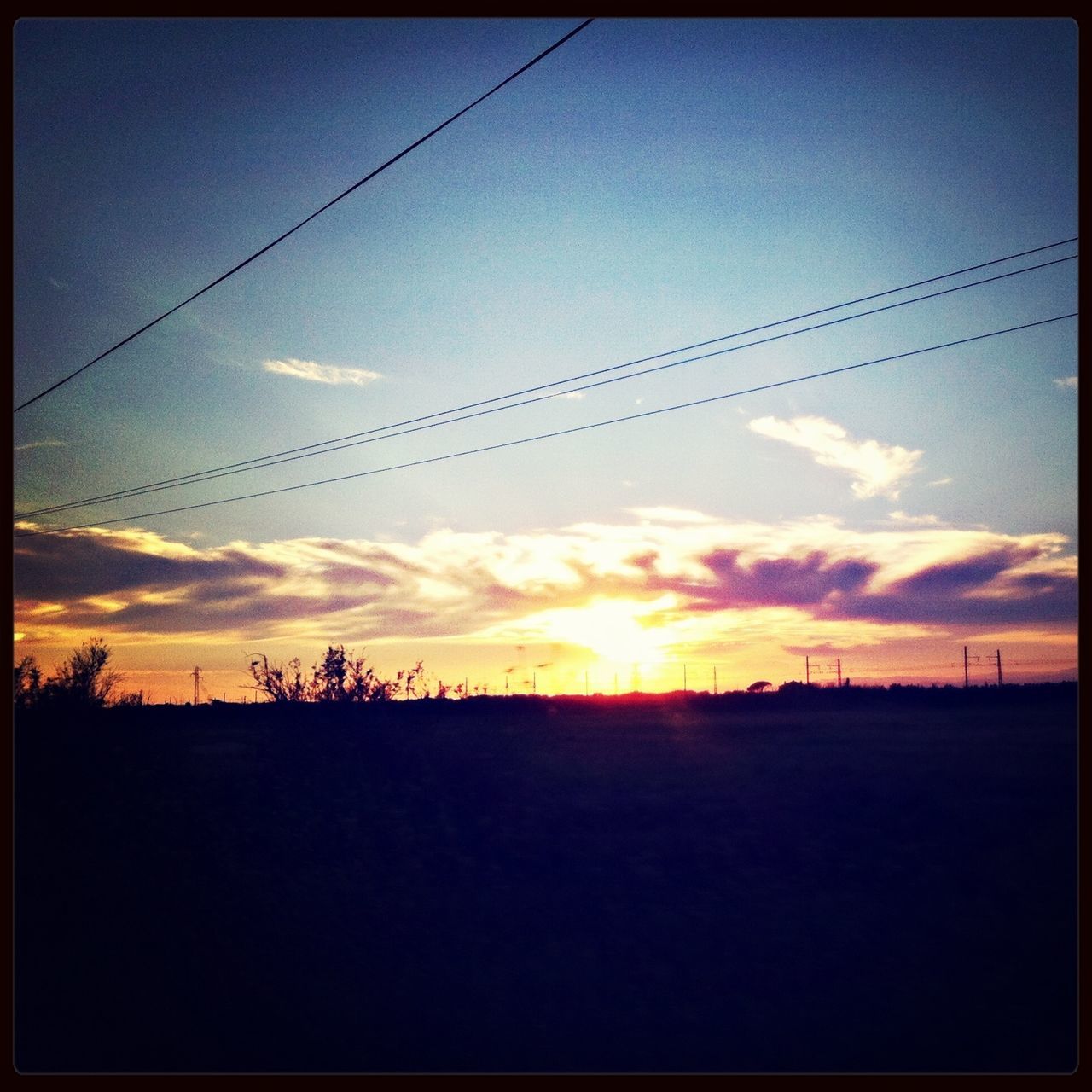 sunset, silhouette, power line, sky, electricity pylon, transfer print, scenics, tranquil scene, orange color, tranquility, beauty in nature, power supply, electricity, landscape, nature, cable, cloud - sky, auto post production filter, cloud, sun