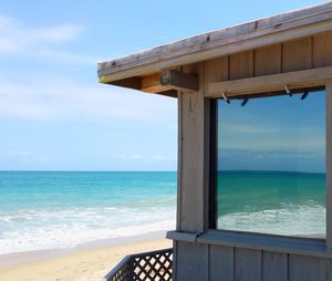 Cropped image of hut at beach against sky