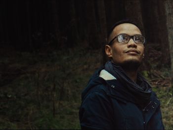 Young man wearing eyeglasses while looking away