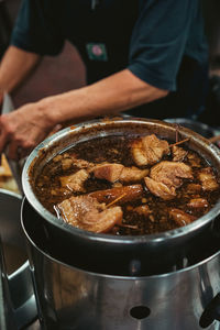 Midsection of man preparing food