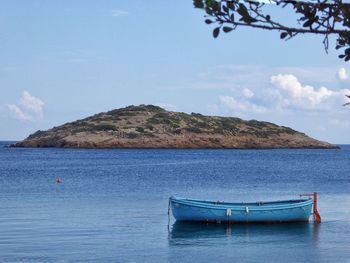 Boat in calm blue sea against sky