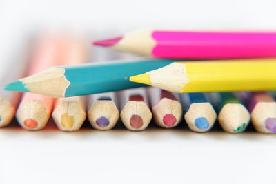 Close-up of multi colored pencils on table