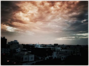 Buildings against cloudy sky