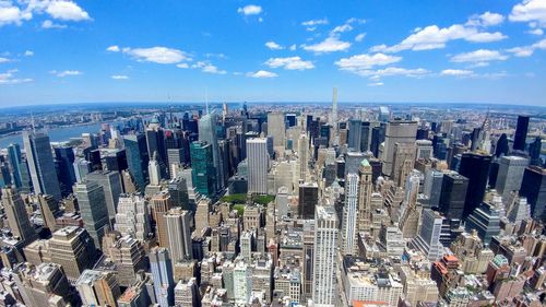 Aerial view of modern buildings in city against sky