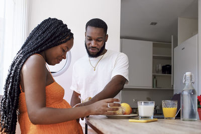 Man taking care of pregnant woman at home