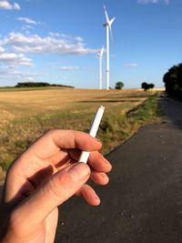 Cropped hand holding cigarette 