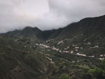 High angle view of land and mountains against sky