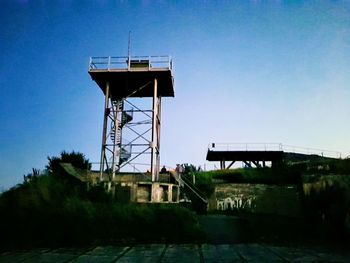 Water tower against clear blue sky