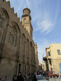 Group of people in historic building against sky in city of cairo 