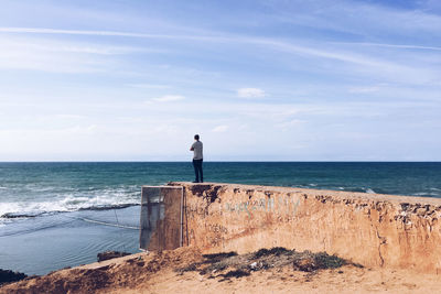 Man looking at sea against sky
