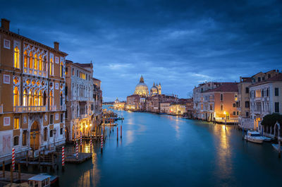Grand canal amidst illuminated buildings in city at dusk
