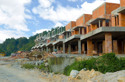 Panoramic view of buildings and mountains against sky