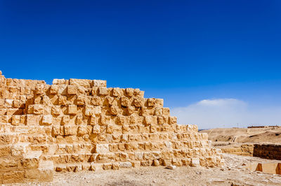 Stone wall against clear blue sky