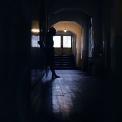 Silhouette of woman in corridor