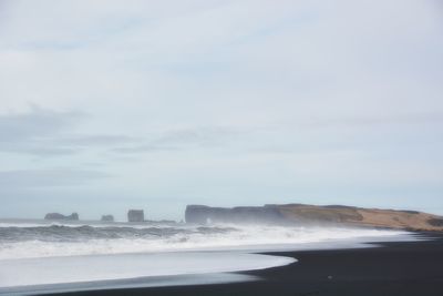Scenic view of waves breaking on shore
