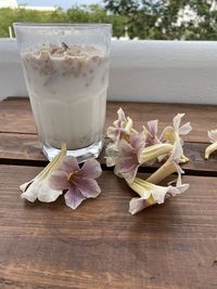 Close-up of glass of white flowers on table