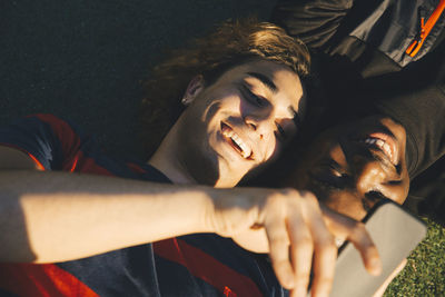 Portrait of smiling young man lying down