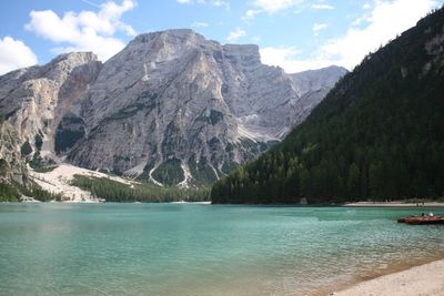 Scenic view of lake by mountains against sky