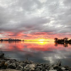 Scenic view of lake against sky during sunset