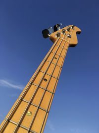 Low angle view of windmill against clear blue sky