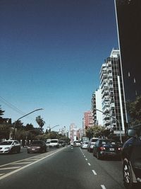 Cars on road against blue sky