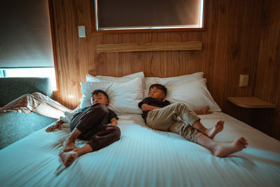 Woman sleeping on bed at home