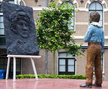 Low section of man standing by statue in city