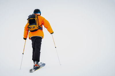 Ski tourist goes uphill. snow and winter sports, ski touring in the mountains, entertainment