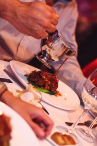 Midsection of man preparing food in restaurant