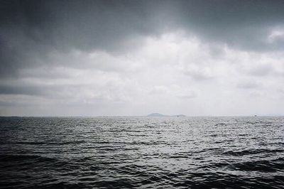 Scenic view of sea against cloudy sky