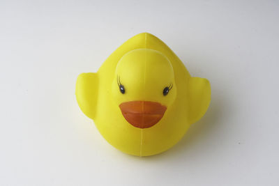 Close-up of yellow toy over white background