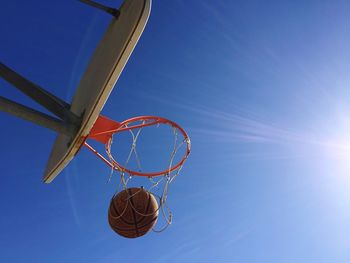 Low angle view of basketball hoop against blue sky