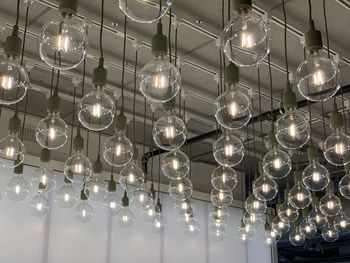 Low angle view of illuminated lights hanging from ceiling