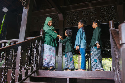 People standing against railing