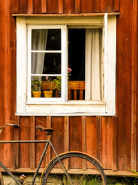 Bicycle by window of building