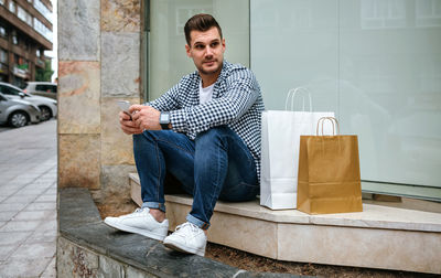 Portrait of young man sitting outdoors
