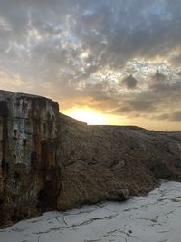 Scenic view of rocky landscape against sky during sunset