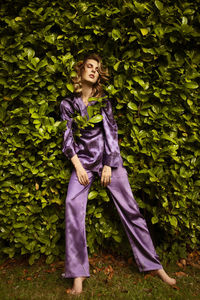 Woman standing against plants