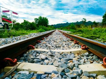 Railroad track against cloudy sky