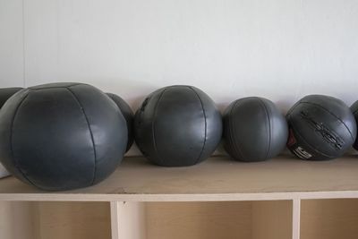 Close-up of balls on table against wall at home