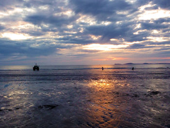 Scenic view of sea against cloudy sky