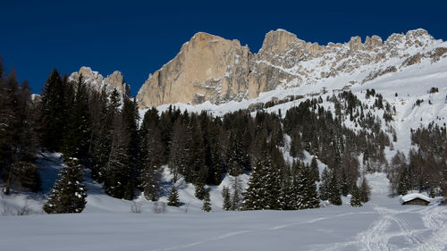 Scenic view of snowcapped mountains against clear sky