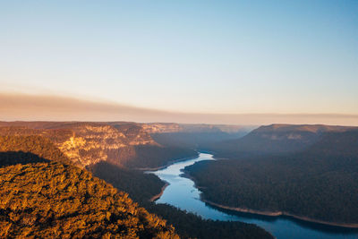 Scenic view of landscape against clear sky during sunset