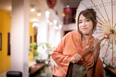 Portrait of a smiling young woman standing outdoors